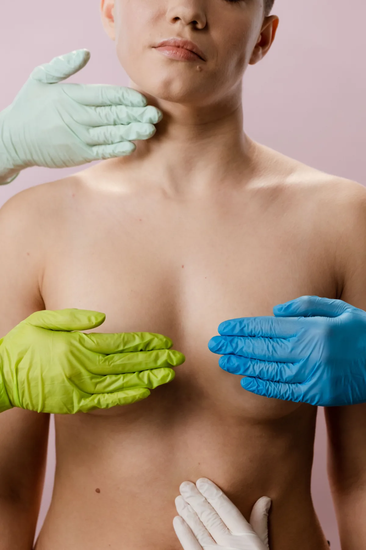 Gloved hands demonstrating gentle lymphatic care around the neck and chest