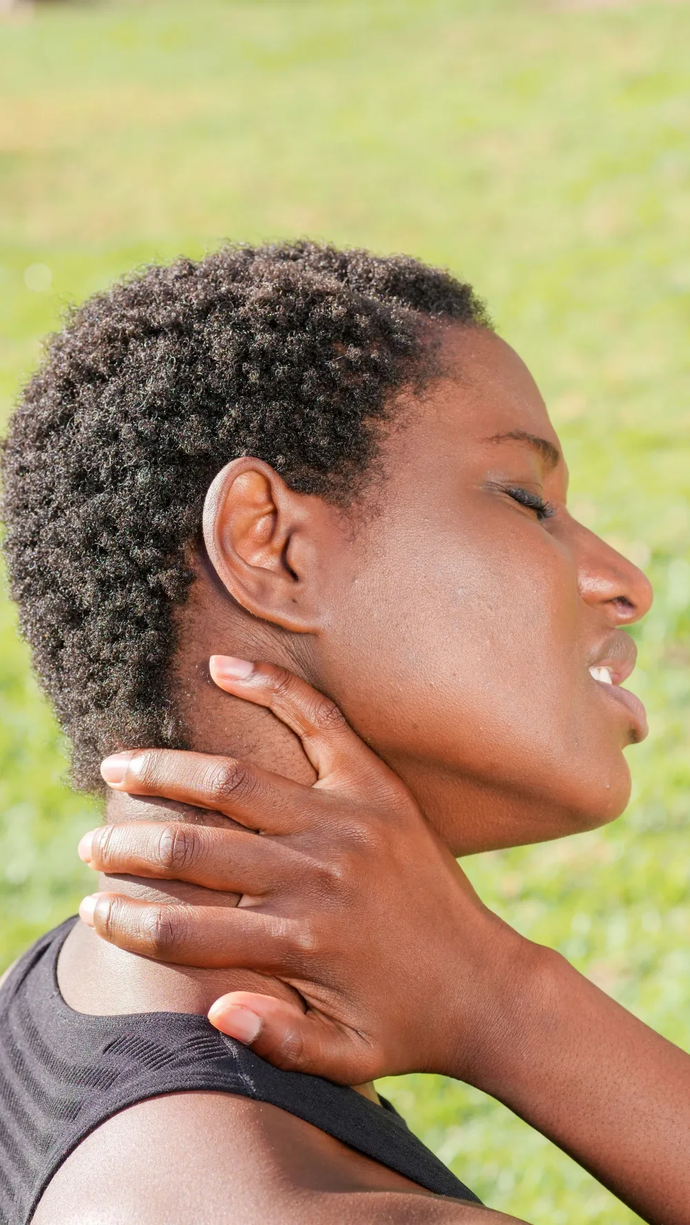 Person gently supporting their neck during lymphatic care