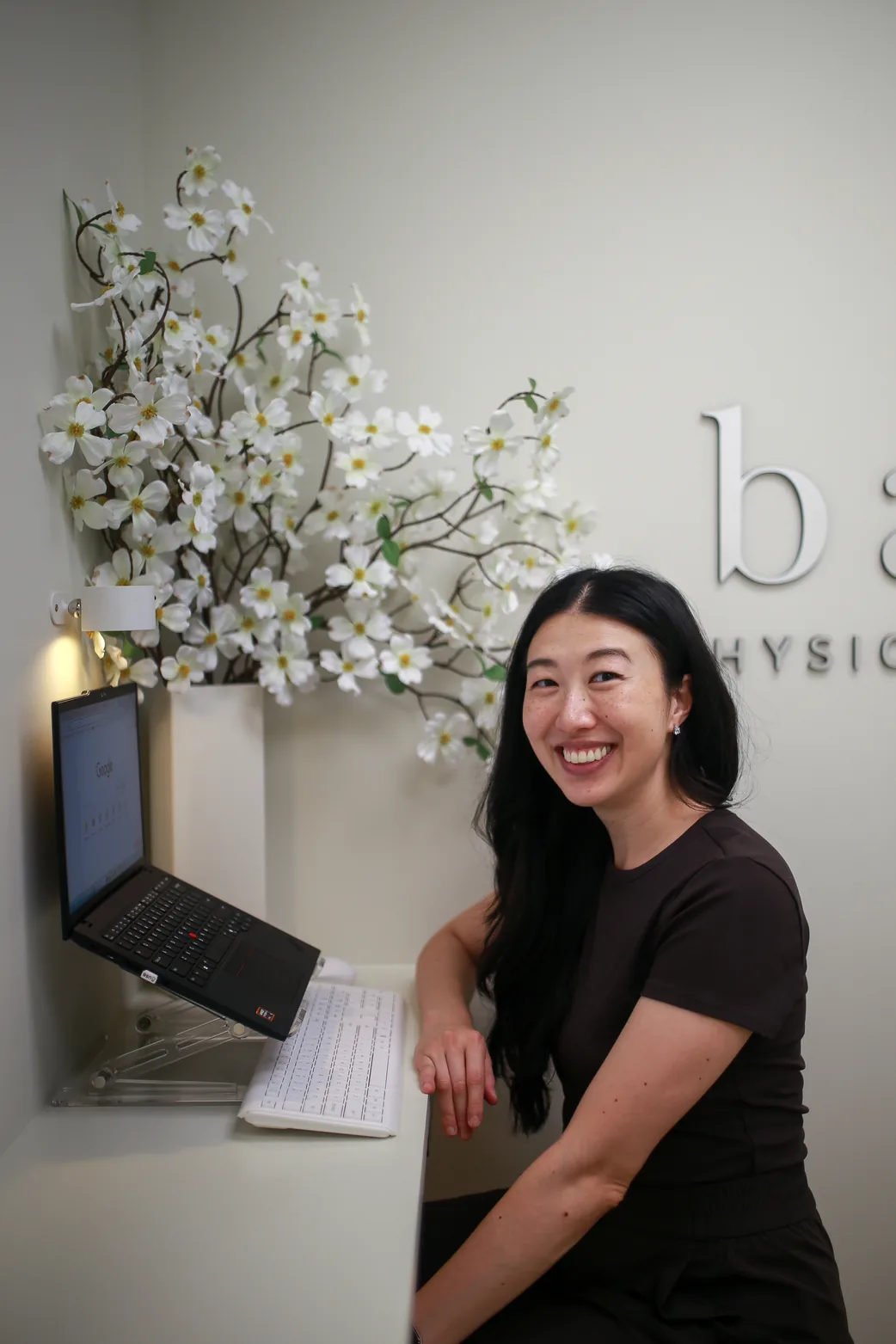 Dr. Carolyn Baek at her clinic workstation
