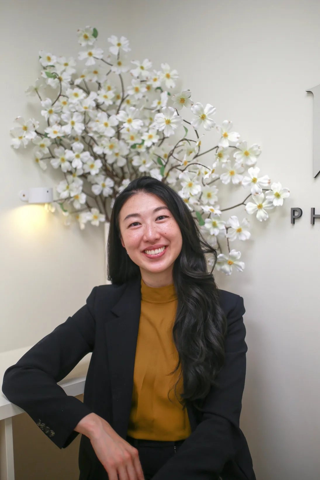 Dr. Carolyn Baek seated at Baek Physical Therapy & Wellness